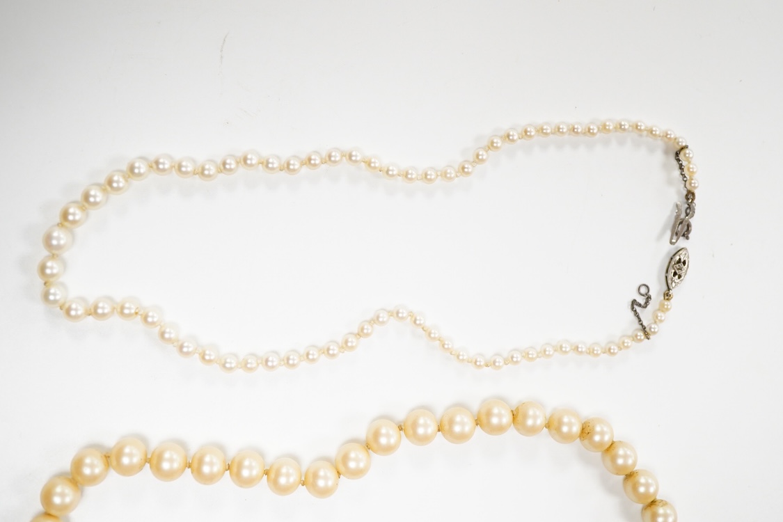 Two single strand graduated cultured pearl necklaces, one with a single stone rose cut diamond set 9ct white metal clasp, 42cm, together with a simulated pearl necklace and three assorted costume brooches.